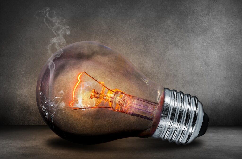 A glowing filament inside a smoky light bulb.