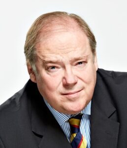 Portrait of a middle-aged man in a suit with a confident expression.