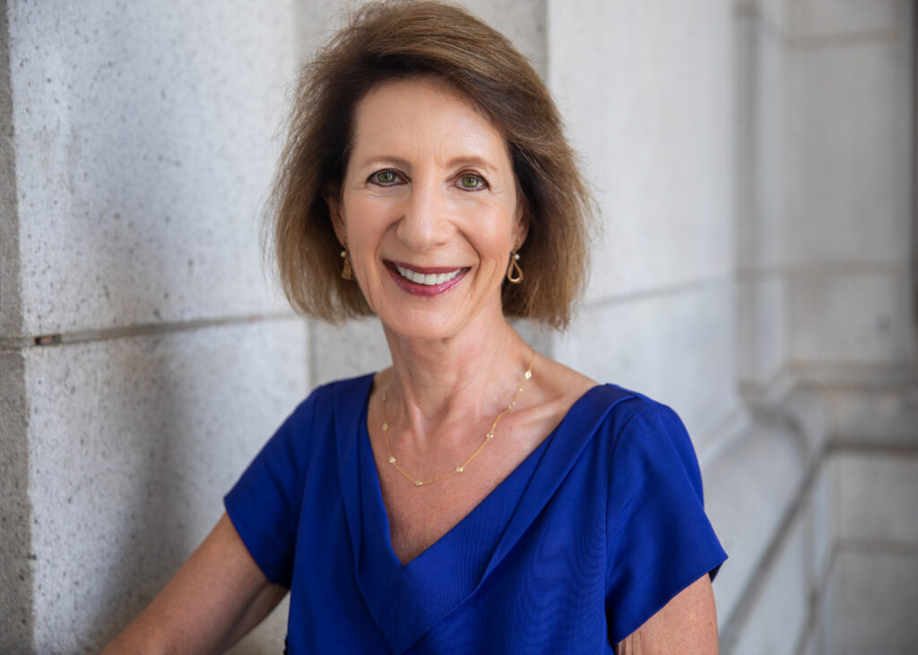 Smiling woman in blue dress and jewelry