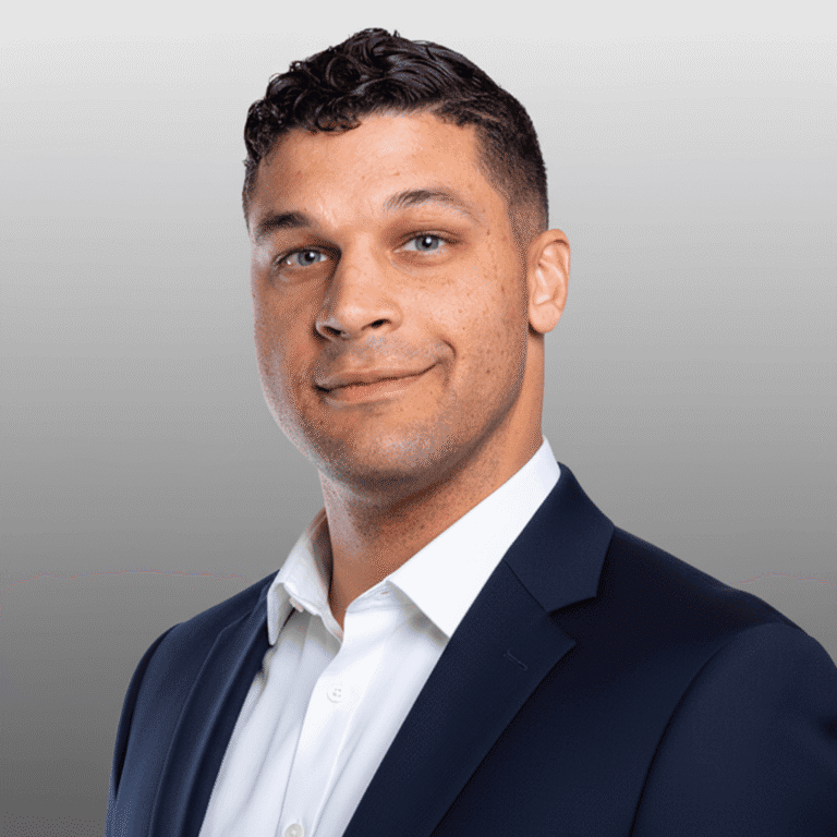 Man in suit with neutral expression.